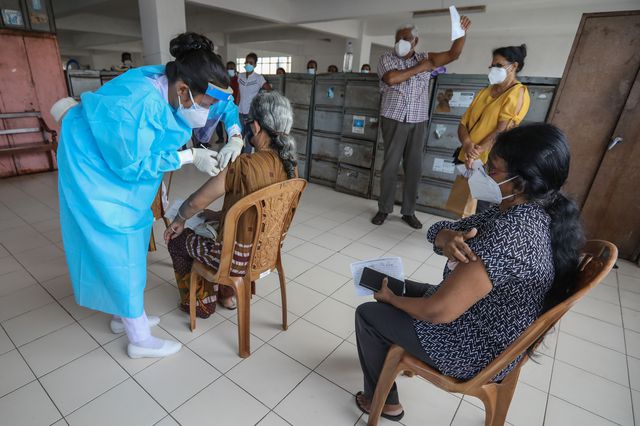 Senior citizens receive the booster dose of COVID-19 vaccine at a vaccination clinic in Colombo, Sri Lanka, November 30th, 2021. Sri Lanka is currently using Pfizer-BioNTech, Oxford-AstraZeneca, China's Sinopharm and Sinovac, Russian Sputnik V and Moderna COVID-19 vaccines.